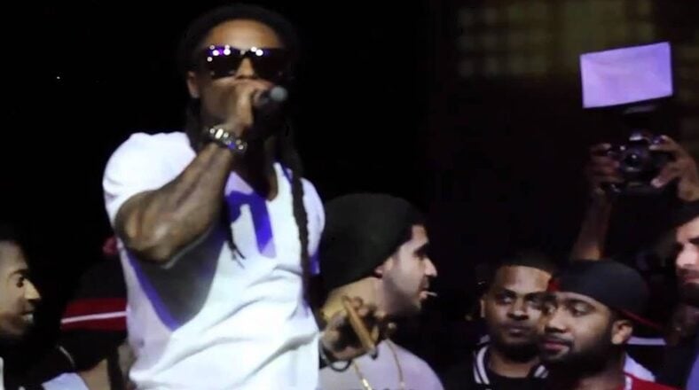 Lil Wayne performs at a Super Bowl party. Now, he's delaying the "6 Foot, 7 Foot" video.