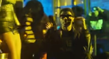 Travis Porter in the "Bring It Back" music video, performing with high energy in a club setting.