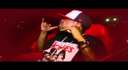 Brisco in “Bitch I’m Paid” music video scene