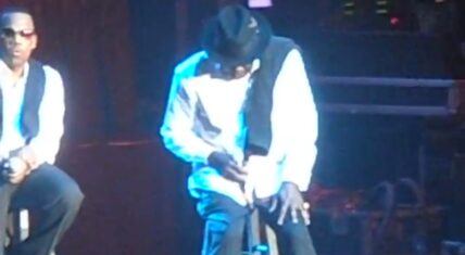 Bobby Brown performing on stage during New Edition concert as he reacts to Whitney Houston’s death.