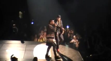 Jay-Z and Kanye West performing on stage during their "Watch the Throne" tour, with footage expected in the "Niggas In Paris" music video premiering today on MTV.