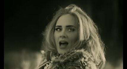 Adele singing in her “Hello” music video, directed by Xavier Dolan