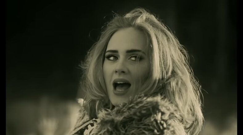 Adele singing in her “Hello” music video, directed by Xavier Dolan