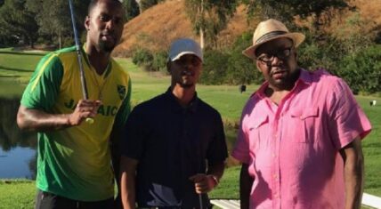 Bobby Brown stands with Lil Fizz and Safaree on a golf course, filming for "Love & Hip Hop Hollywood"