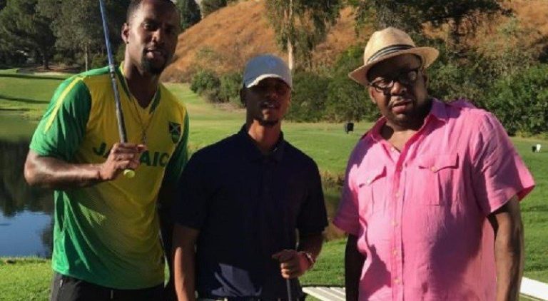 Bobby Brown stands with Lil Fizz and Safaree on a golf course, filming for "Love & Hip Hop Hollywood"