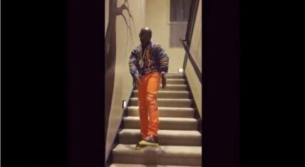 Floyd Mayweather standing on a staircase, dressed stylishly, as he shows off his new private jet.