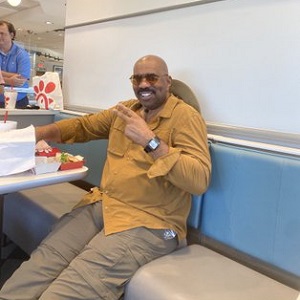 Steve Harvey was posted on Twitter, by Kanye West. The two were eating Chick-Fil-A, but that's not what people noticed. On Twitter, Steve Harvey is trending, because fans noticed the bulge between his legs, saying he's packing that loud.
