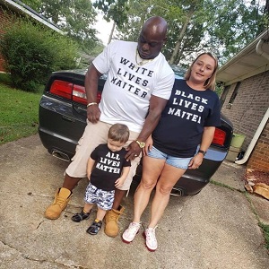 Elizabeth White, a well-known local news correspondent, has now jumped into the Black Lives Matter conversation. Some friends of hers recently adopted a child, a selfless act, and she shared their photo on her Facebook. Her friends are an interracial couple and they adopted a white child. The couple posed for a photo, which attempted to silence the race debate currently ongoing, with the black husband wearing a "White Lives Matter" shirt, the white wife wearing a "Black Lives Matter" shirt, and the child wearing an "All Lives Matter" shirt, sparking controversy on Facebook.