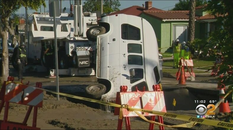 Amber Anderson's van falls into sinkhole, in front of her home in Crenshaw, Los Angeles.