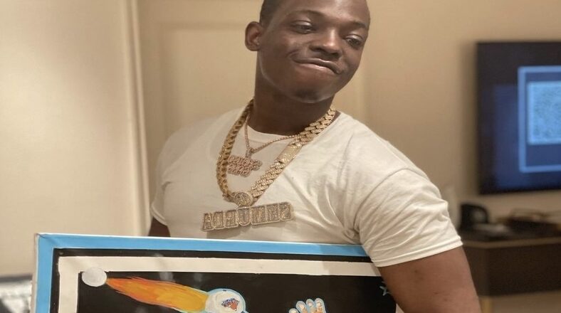Bobby Shmurda Holding Painting