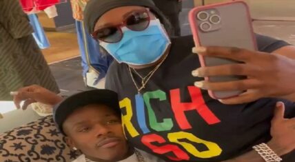 DaBaby has a female fan sitting on his lap