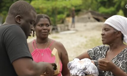 Zoey Dollaz distributing supplies to Haitian residents affected by the earthquake.