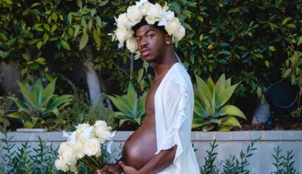 Lil Nas X poses with a pregnancy belly in a maternity-themed photoshoot to promote his album "Montero."