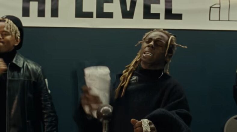 Lil Wayne accused of pulling assault rifle on his bodyguard and is under investigation, but people close to him deny this happened