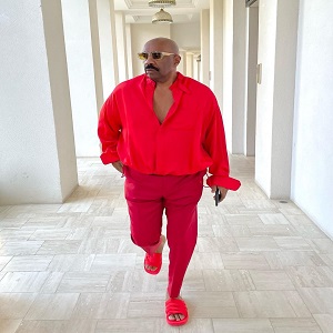 Steve Harvey rocks Virgil Abloh Louis Vuitton red outfit with his chest out