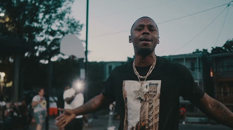 YBS Skola holds down his hood in Westside video