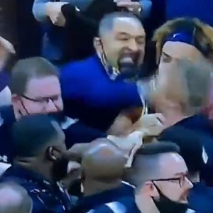 Juwan Howard punches Wisconsin assistant coach causing brawl