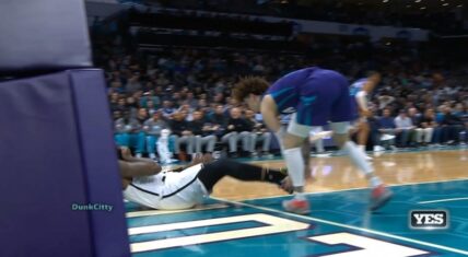 LaMelo Ball tries to catch Andre Drummond as he falls