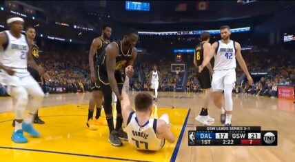 Draymond Green helps Luka Doncic up after blocking him