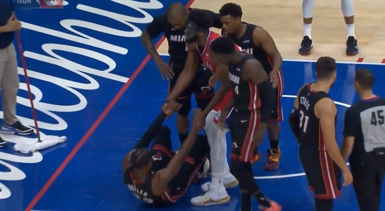 Joel Embiid helps Jimmy Butler up after he smacked him in the face