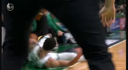 Jayson Tatum slides down the court trying to save the ball