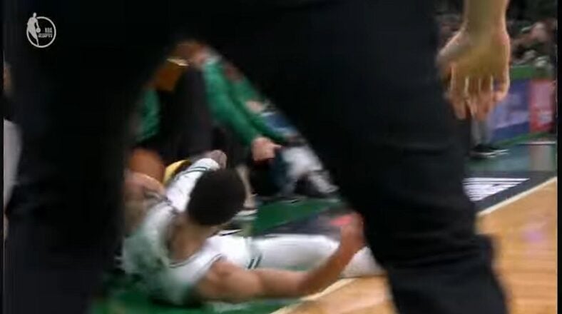Jayson Tatum slides down the court trying to save the ball