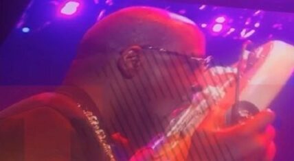Wyclef Jean plays the guitar with his tongue at Essence Fest