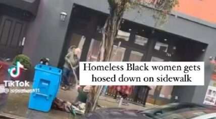 White man hoses down a homeless Black woman