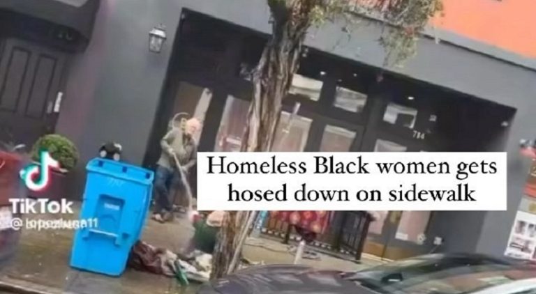 White man hoses down a homeless Black woman