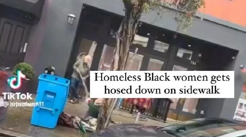 White man hoses down a homeless Black woman