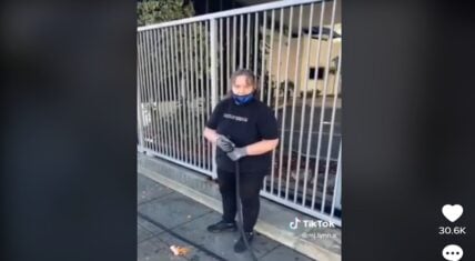 White woman sprays Black homeless people with water hose