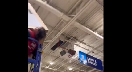 Lowe's employee gets stuck on lift holding heavy box