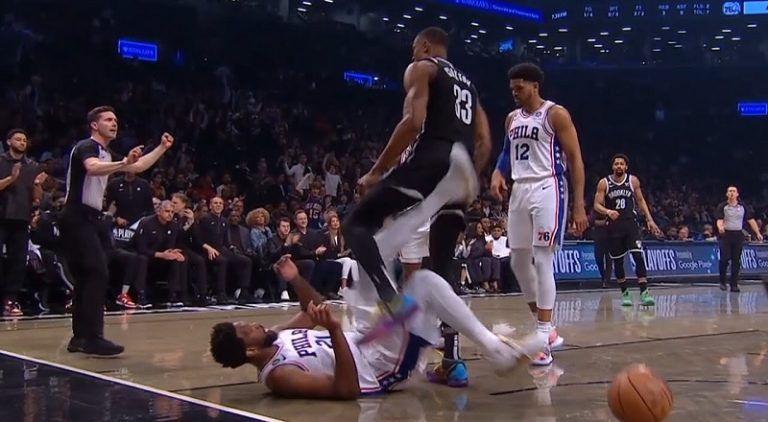 Joel Embiid kicks Nic Claxton after Claxton stepped over him