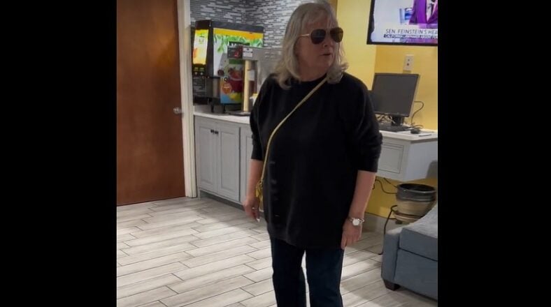 Two women involved in a physical altercation at a hotel after one spits on the other, prompting a self-defense response.