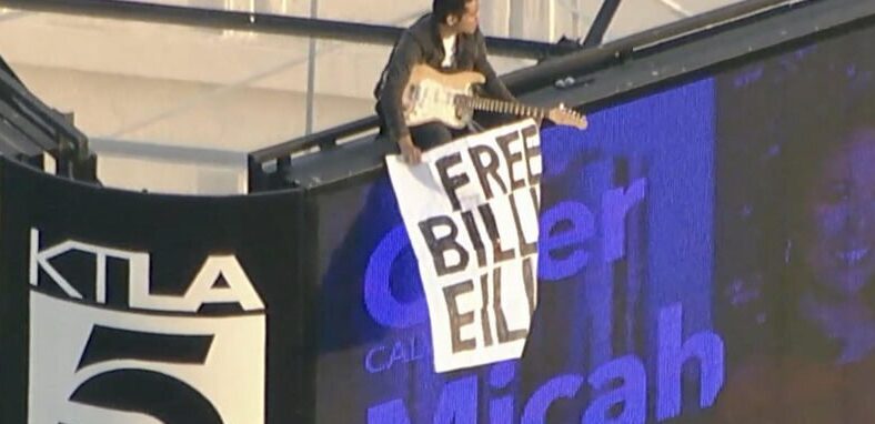 Billie Eilish fan holds "Free Billie Eilish" sign on top of KTLA tower