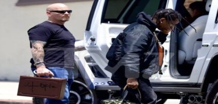 Travis Scott's security guard wears handcuffed "Utopia" briefcase
