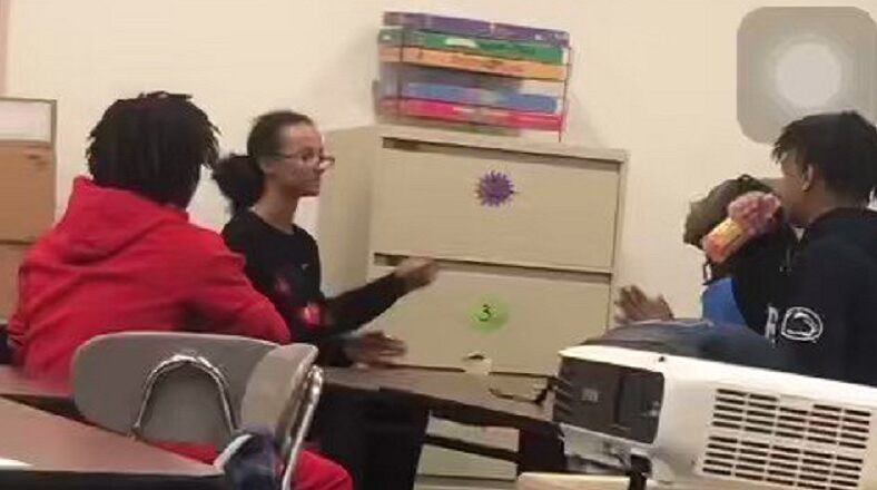 Teacher checks students for using the n-word in class