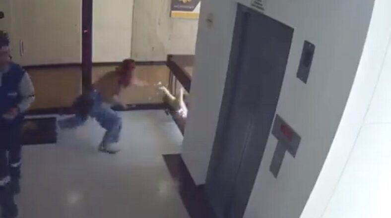 Woman grabs son's leg and stops him from falling over balcony