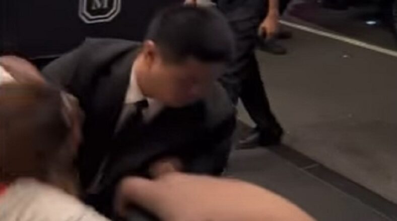 Drake's security wrestles a woman trying to run to him