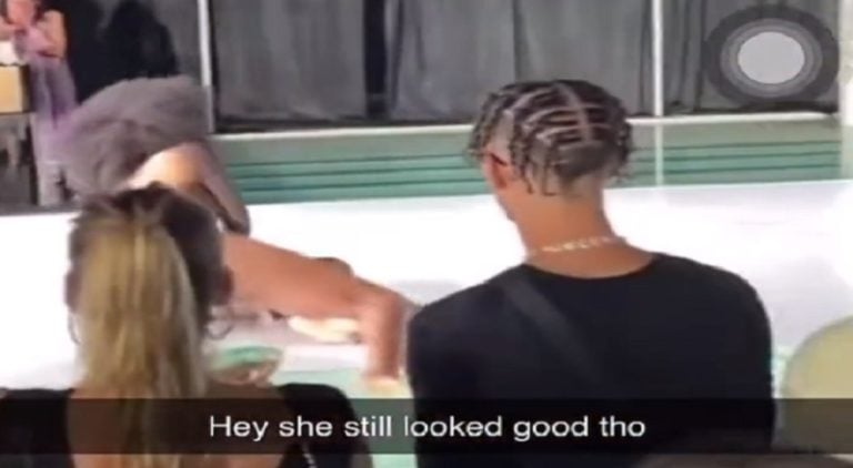 Model slips and falls while walking down the runway