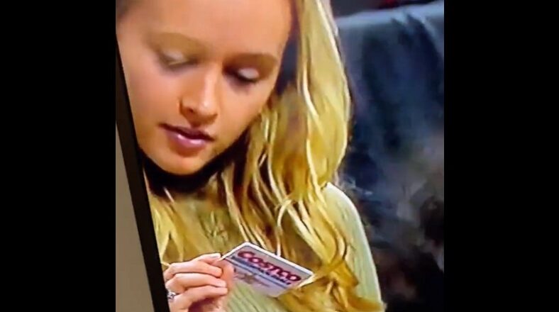 Teen shows off Costco card to girl during televised basketball game