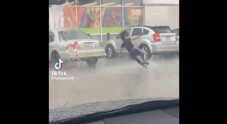 Woman slips and falls while running in the rain