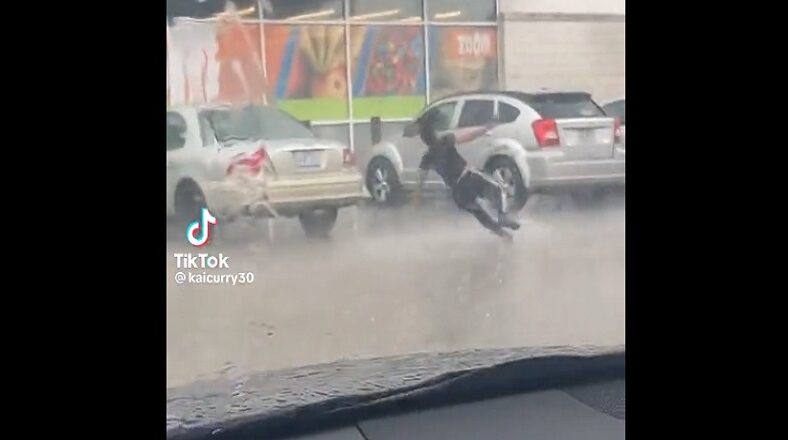 Woman slips and falls while running in the rain