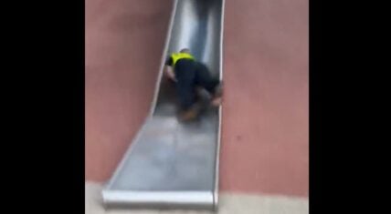 Boston police officer falls backwards down children's slide