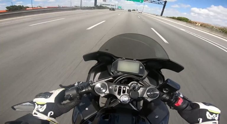 Police officer slams on brakes so a biker can crash into him