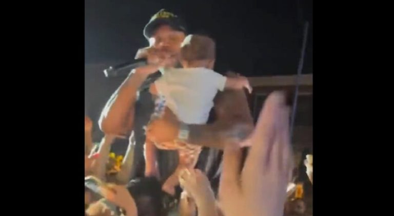 Woman crowd surfs her baby to Flo Rida during concert