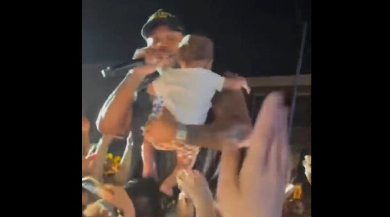 Woman crowd surfs her baby to Flo Rida during concert