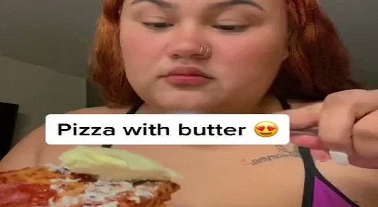 Woman eats her pizza slice by dipping it in butter