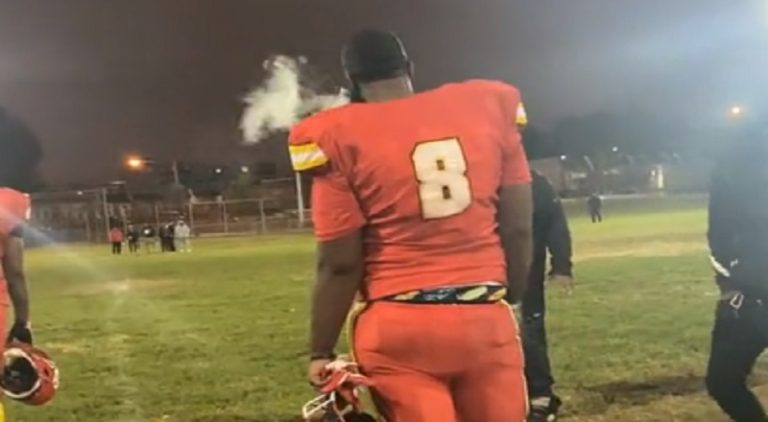 Football player caught on camera smoking during the game