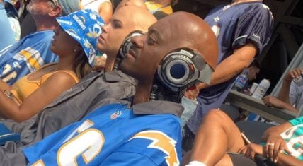Man sits beside robot couple during LA Chargers game
